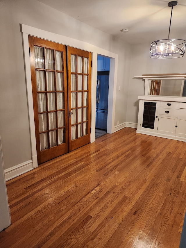 2250 N Dayton St Unit 3, Chicago, IL 60614 - kitchen with stainless steel refrigerator, wood finished floors, white cabinetry, a chandelier, and baseboards