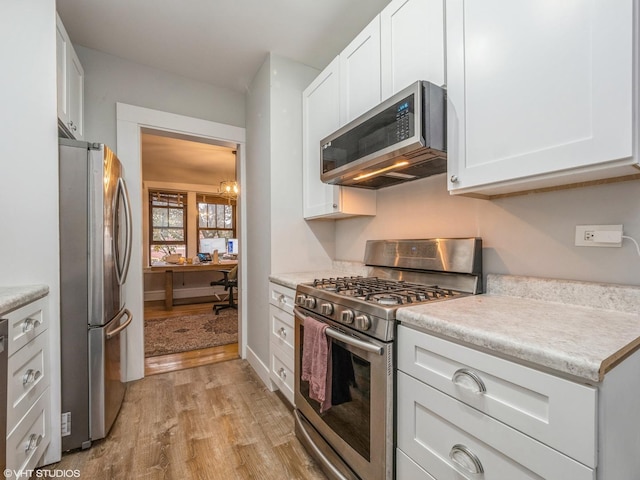 2250 N Dayton St Unit 3, Chicago, IL 60614 - kitchen featuring stainless steel appliances, light wood finished floors, white cabinetry, and light countertops
