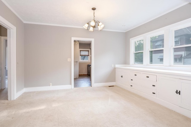 217 W Moulton St, Pontiac, IL 61764 - unfurnished dining area with a chandelier, light colored carpet, and ornamental molding