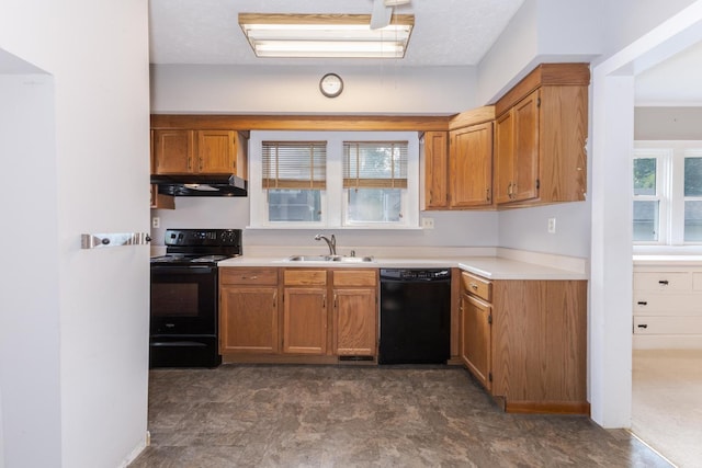 217 W Moulton St, Pontiac, IL 61764 - kitchen with black appliances, under cabinet range hood, brown cabinets, and light countertops