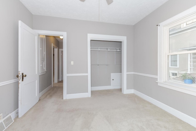 217 W Moulton St, Pontiac, IL 61764 - unfurnished bedroom featuring light carpet, a closet, and ceiling fan