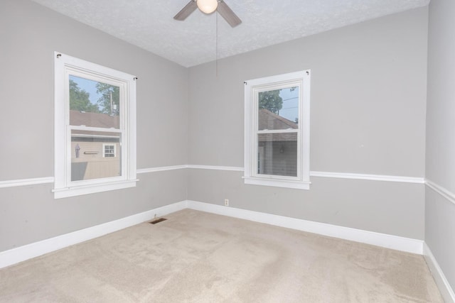 217 W Moulton St, Pontiac, IL 61764 - unfurnished room featuring carpet flooring, a textured ceiling, and a ceiling fan