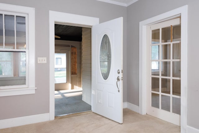 217 W Moulton St, Pontiac, IL 61764 - carpeted foyer entrance with healthy amount of natural light and crown molding
