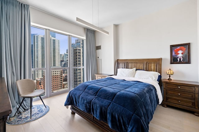 600 N Dearborn St Unit 2005, Chicago, IL 60654 - bedroom featuring light wood-style flooring and a view of skyline