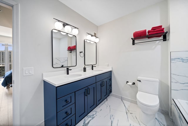 600 N Dearborn St Unit 2005, Chicago, IL 60654 - bathroom with marble look tile flooring, double vanity, ensuite bathroom, baseboards, and toilet