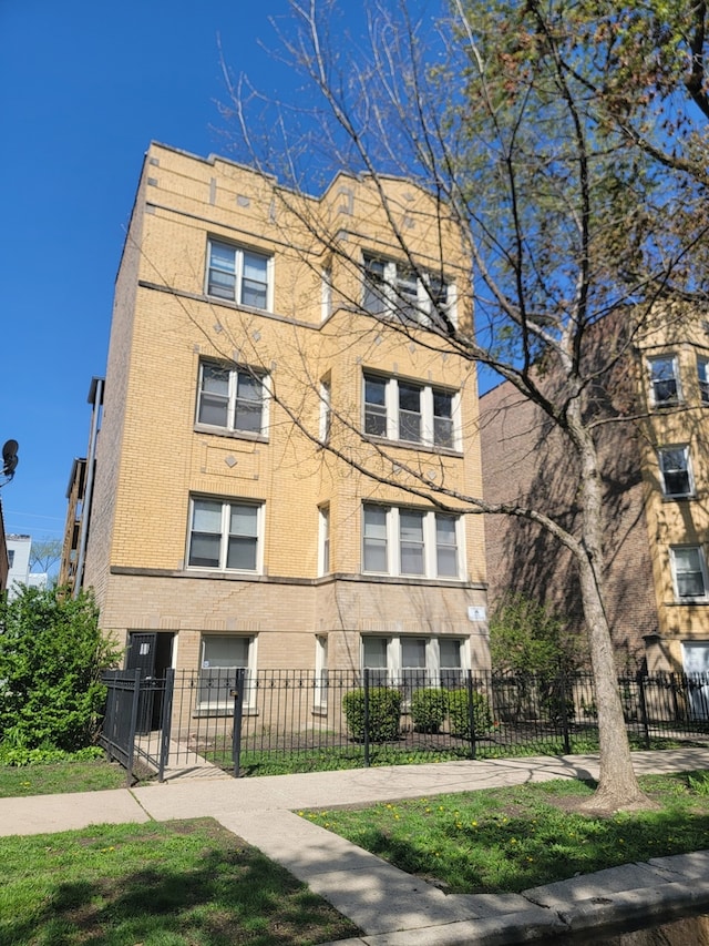 4104 N Mozart St Unit Ge, Chicago, IL 60618 - view of apartment building / complex featuring a fenced front yard