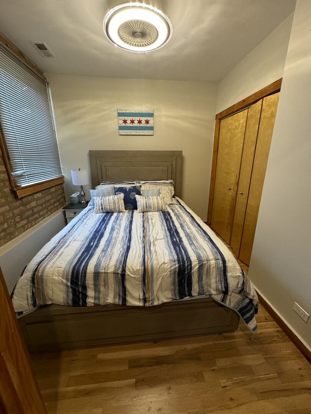 4104 N Mozart St Unit Ge, Chicago, IL 60618 - bedroom with wood finished floors, a closet, and baseboards