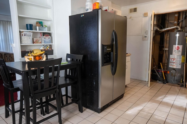 347 Manitowac St, Park Forest, IL 60466 - kitchen featuring water heater, stainless steel fridge, built in shelves, and light tile patterned floors