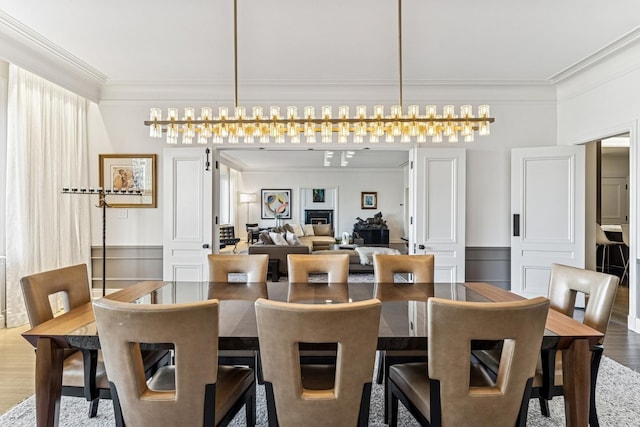 209 E Lake Shore Dr Unit 3W, Chicago, IL 60611 - dining space featuring crown molding, wood finished floors, and wainscoting