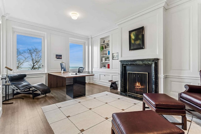 209 E Lake Shore Dr Unit 3W, Chicago, IL 60611 - home office featuring a decorative wall, built in features, ornamental molding, wood finished floors, and a high end fireplace