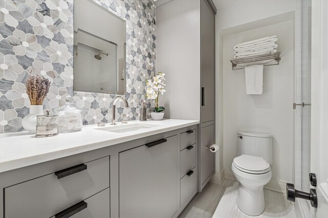 209 E Lake Shore Dr Unit 3W, Chicago, IL 60611 - bathroom featuring decorative backsplash, vanity, toilet, and baseboards