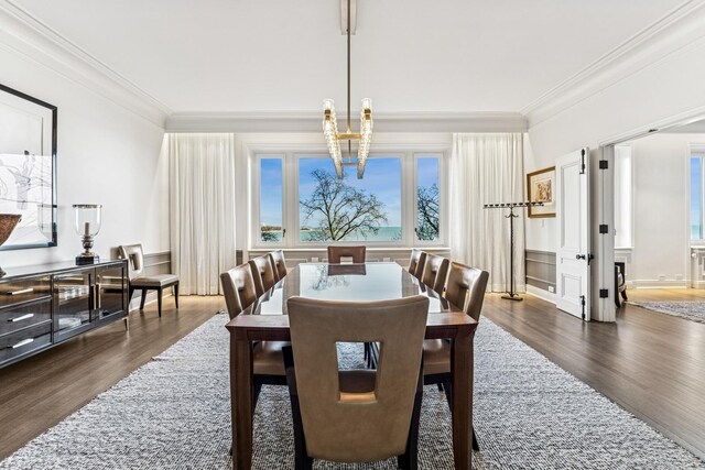 209 E Lake Shore Dr Unit 3W, Chicago, IL 60611 - dining space featuring dark wood-type flooring, ornamental molding, a decorative wall, and wainscoting