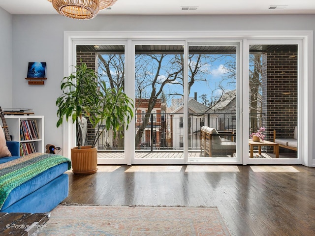 2422 W Lyndale St Unit 2, Chicago, IL 60647 - doorway featuring wood finished floors and a chandelier