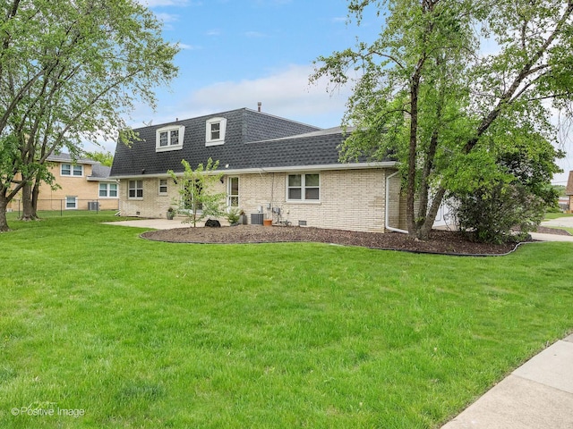 7514 Nantucket Dr, Darien, IL 60561 - back of property featuring a shingled roof, a yard, mansard roof, brick siding, and central AC unit
