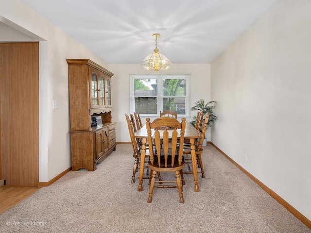 7514 Nantucket Dr, Darien, IL 60561 - dining space featuring a chandelier, light colored carpet, and baseboards