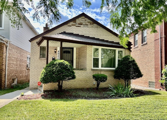 8920 S Jeffery Blvd, Chicago, IL 60617 - view of front facade with a front yard and brick siding
