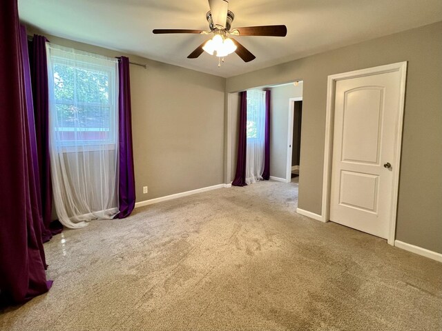 8920 S Jeffery Blvd, Chicago, IL 60617 - empty room with carpet, ceiling fan, and baseboards