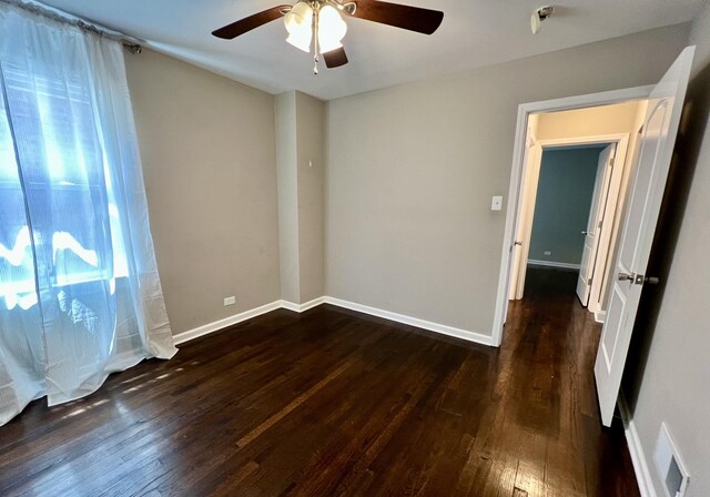 8920 S Jeffery Blvd, Chicago, IL 60617 - empty room with ceiling fan, wood finished floors, and baseboards