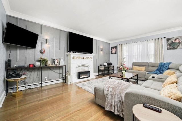 10807 S Wentworth Ave, Chicago, IL 60628 - living room with crown molding, wood finished floors, a glass covered fireplace, and a baseboard heating unit