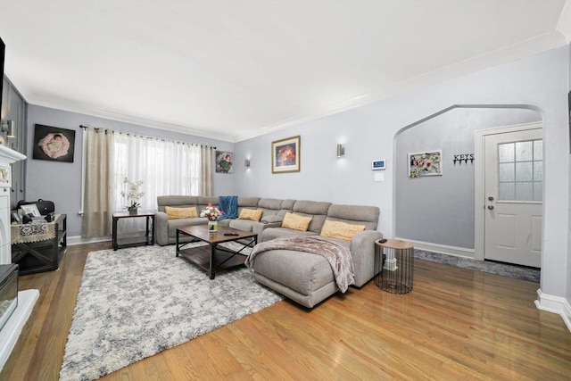 10807 S Wentworth Ave, Chicago, IL 60628 - living room featuring wood finished floors, crown molding, arched walkways, and baseboards