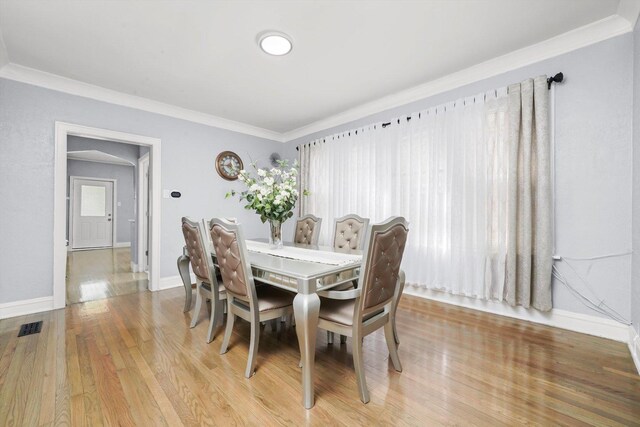 10807 S Wentworth Ave, Chicago, IL 60628 - dining area with wood finished floors, ornamental molding, and baseboards