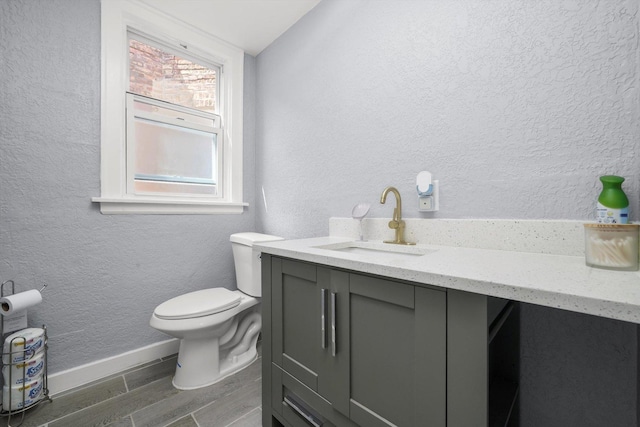 10807 S Wentworth Ave, Chicago, IL 60628 - half bath featuring vanity, wood finished floors, and a textured wall