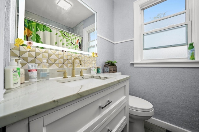 10807 S Wentworth Ave, Chicago, IL 60628 - bathroom featuring a textured wall, decorative backsplash, vanity, plenty of natural light, and curtained shower