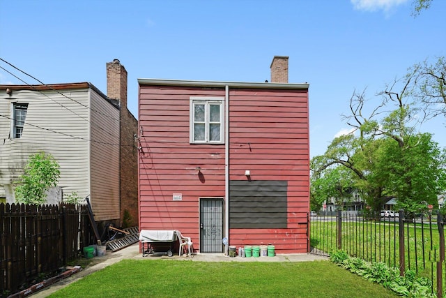 10807 S Wentworth Ave, Chicago, IL 60628 - rear view of property featuring a chimney