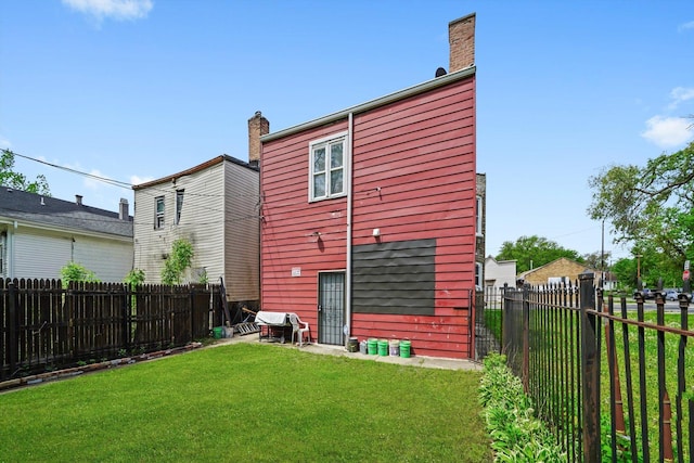10807 S Wentworth Ave, Chicago, IL 60628 - rear view of house featuring a chimney