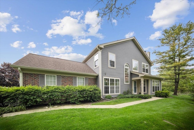 1148 Coldspring Rd Unit 0, Elgin, IL 60120 - rear view of house with a yard, brick siding, and a chimney