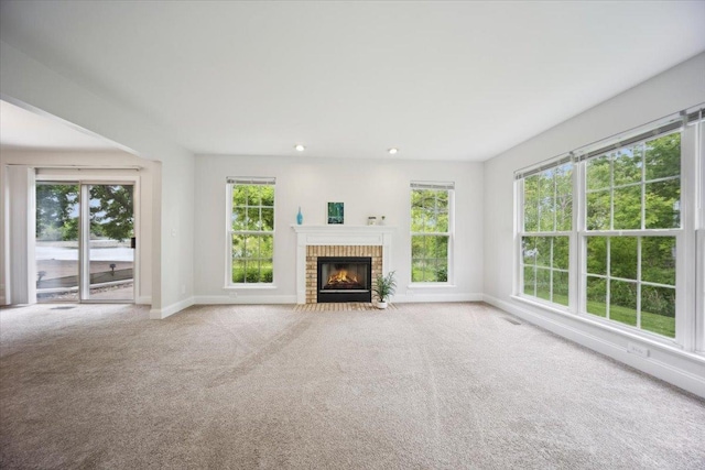 1148 Coldspring Rd Unit 0, Elgin, IL 60120 - unfurnished living room with baseboards, a brick fireplace, carpet floors, and recessed lighting
