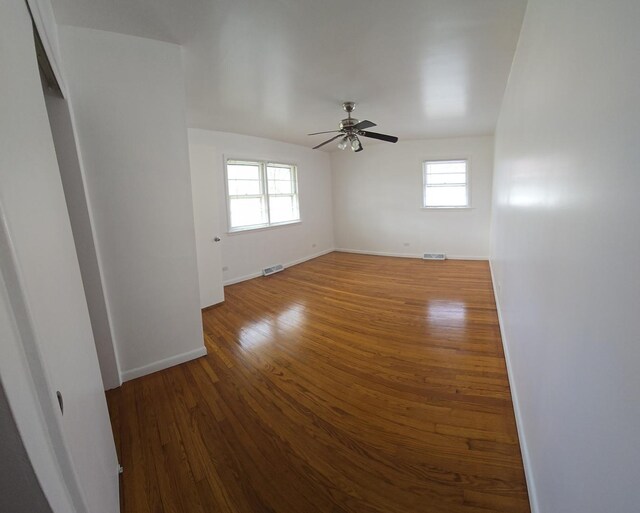 18433 Arcadia St, Lansing, IL 60438 - empty room with a ceiling fan, baseboards, healthy amount of natural light, and wood finished floors