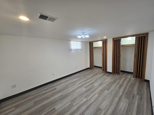 18433 Arcadia St, Lansing, IL 60438 - unfurnished bedroom with two closets, wood finished floors, baseboards, and recessed lighting