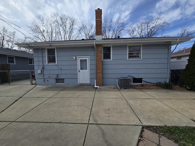 18433 Arcadia St, Lansing, IL 60438 - rear view of house with a chimney, a patio area, and cooling unit