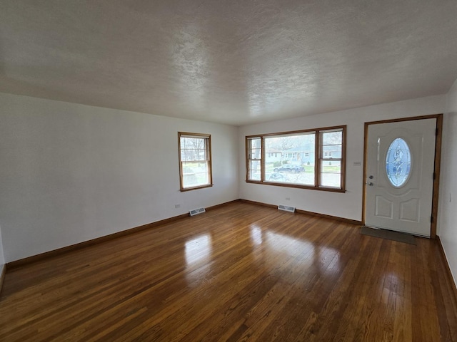 18433 Arcadia St, Lansing, IL 60438 - entrance foyer featuring dark wood-type flooring, baseboards, and a textured ceiling
