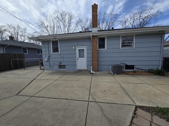 18433 Arcadia St, Lansing, IL 60438 - back of property with central air condition unit, a chimney, a patio, and a gate