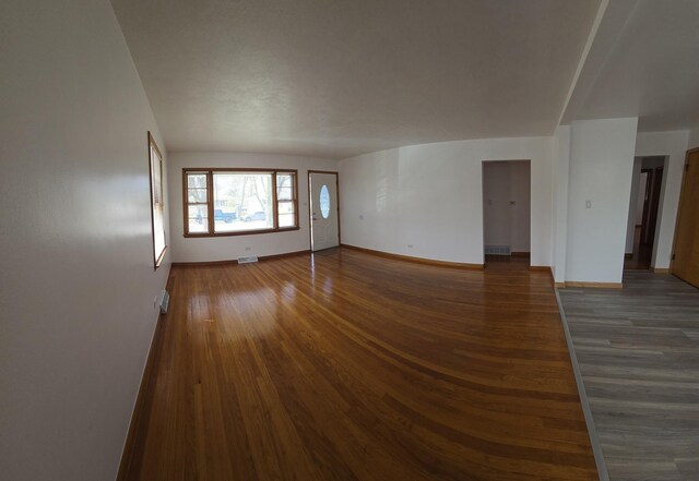 18433 Arcadia St, Lansing, IL 60438 - empty room featuring baseboards, dark wood-style flooring, and lofted ceiling