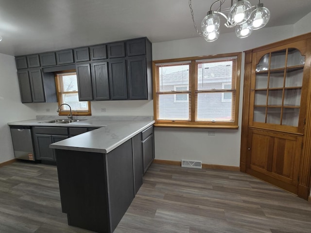 18433 Arcadia St, Lansing, IL 60438 - kitchen with a sink, a peninsula, a chandelier, stainless steel dishwasher, and baseboards