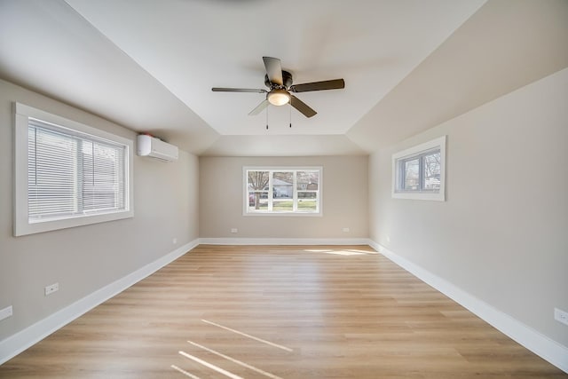 21967 Millard Ave, Richton Park, IL 60471 - spare room featuring a wall unit AC, a ceiling fan, light wood finished floors, and baseboards