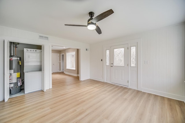 21967 Millard Ave, Richton Park, IL 60471 - foyer entrance with stacked washer and clothes dryer, gas water heater, light wood-type flooring, ceiling fan, and baseboards