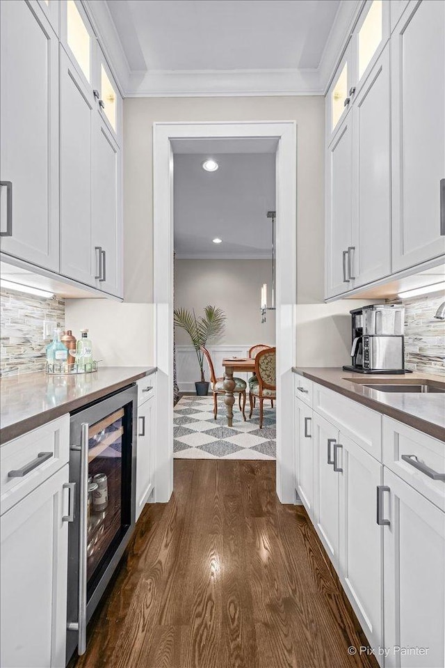 2426 W Warner Ave, Chicago, IL 60618 - bar area with wine cooler, dark wood-style flooring, tasteful backsplash, recessed lighting, and ornamental molding