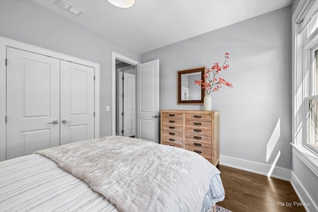 2426 W Warner Ave, Chicago, IL 60618 - bedroom featuring baseboards, dark wood-type flooring, and a closet