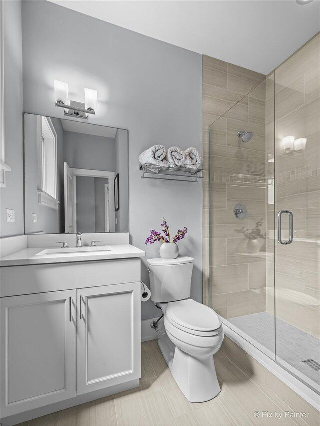 2426 W Warner Ave, Chicago, IL 60618 - bathroom featuring toilet, vanity, and a stall shower