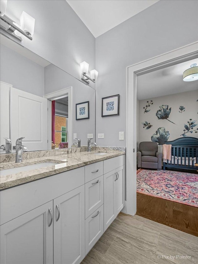 2426 W Warner Ave, Chicago, IL 60618 - bathroom featuring ensuite bath, double vanity, and wood finished floors