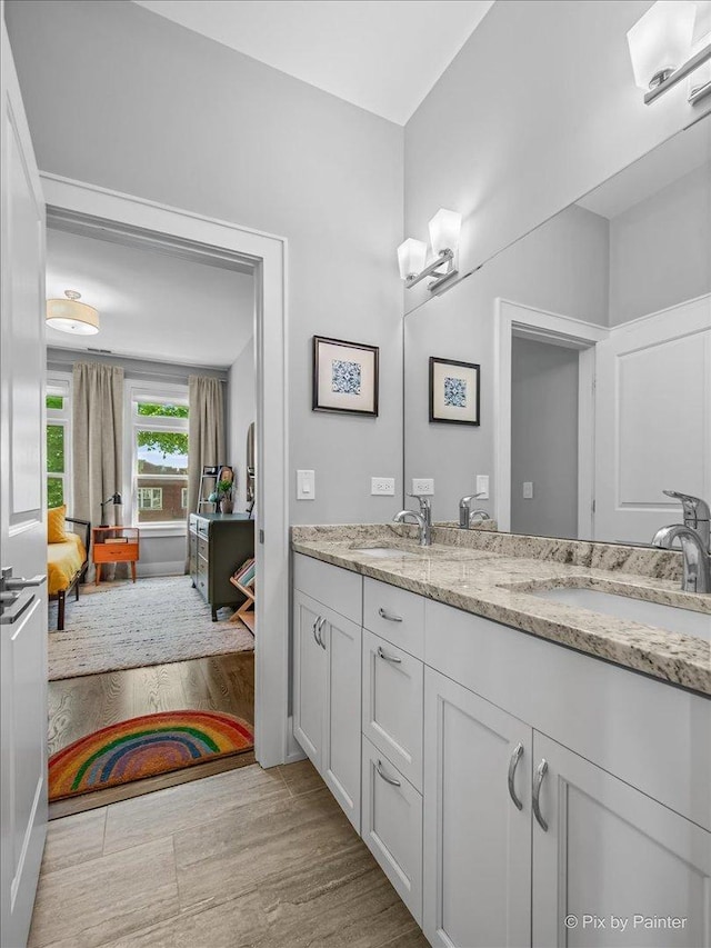 2426 W Warner Ave, Chicago, IL 60618 - full bathroom with double vanity and wood finished floors