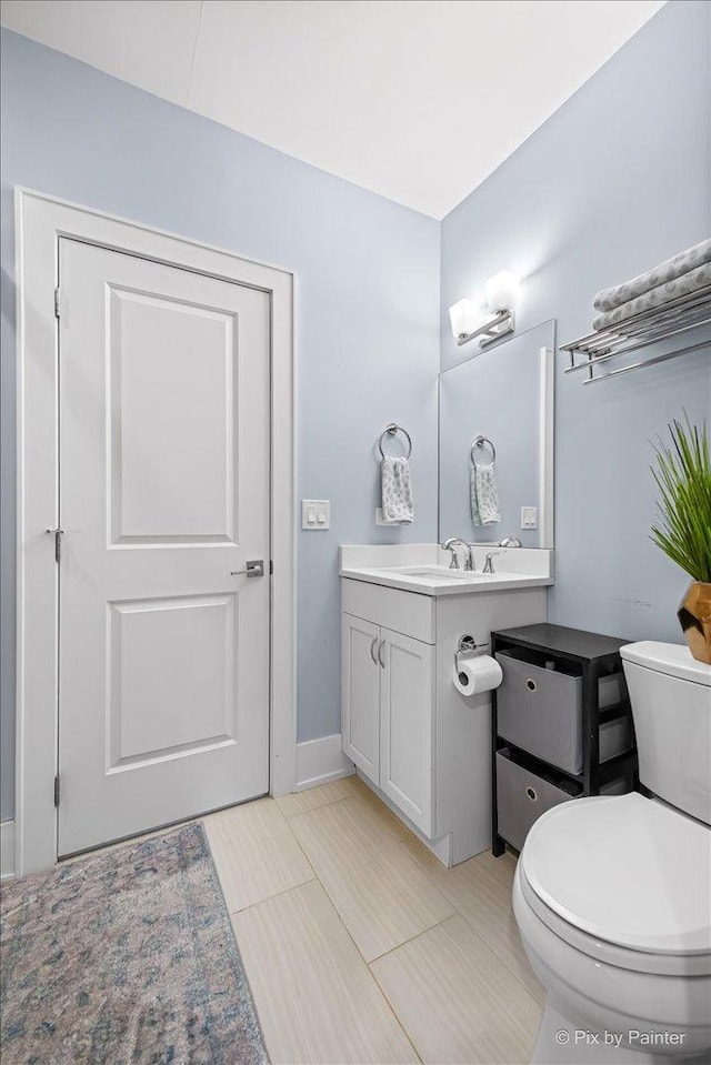 2426 W Warner Ave, Chicago, IL 60618 - bathroom with vanity, toilet, and baseboards