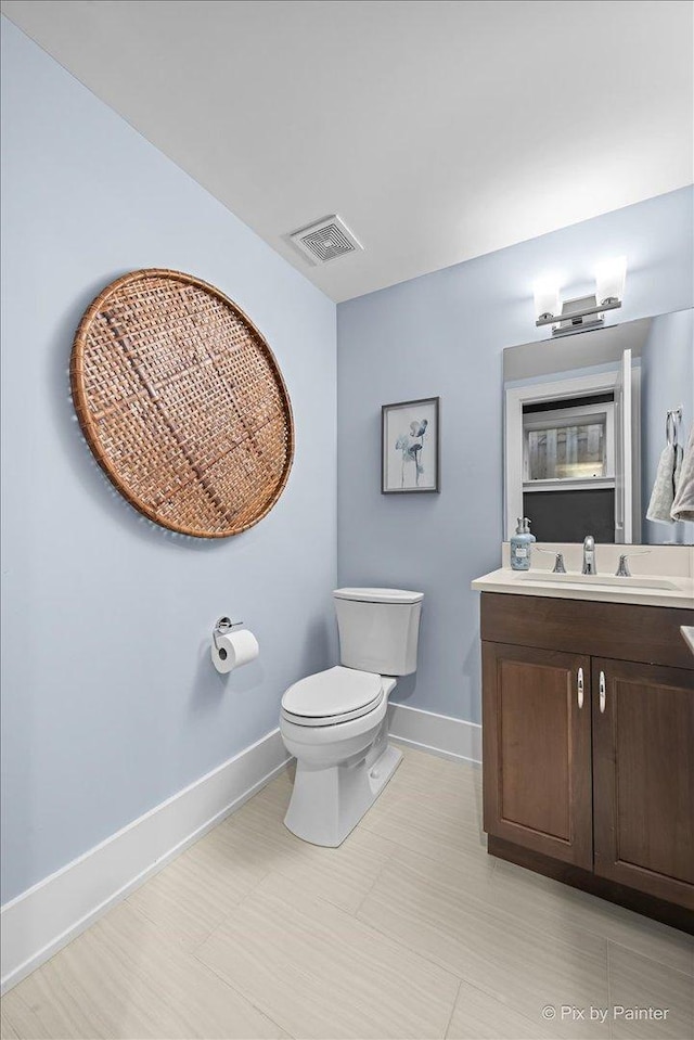 2426 W Warner Ave, Chicago, IL 60618 - bathroom with baseboards, toilet, and vanity