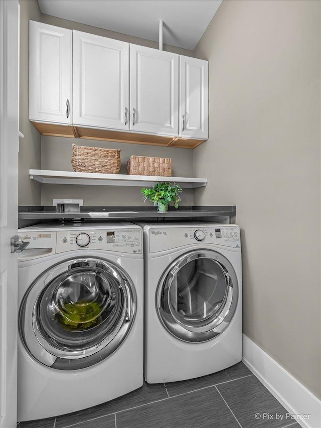 2426 W Warner Ave, Chicago, IL 60618 - laundry room featuring separate washer and dryer, cabinet space, baseboards, and tile patterned flooring