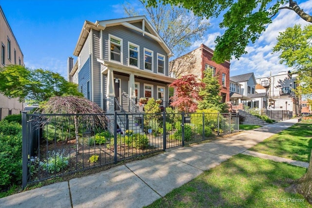 2426 W Warner Ave, Chicago, IL 60618 - american foursquare style home with a porch, a residential view, and a fenced front yard