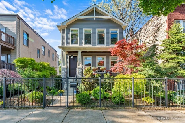 2426 W Warner Ave, Chicago, IL 60618 - view of front of property with covered porch, a fenced front yard, and a gate